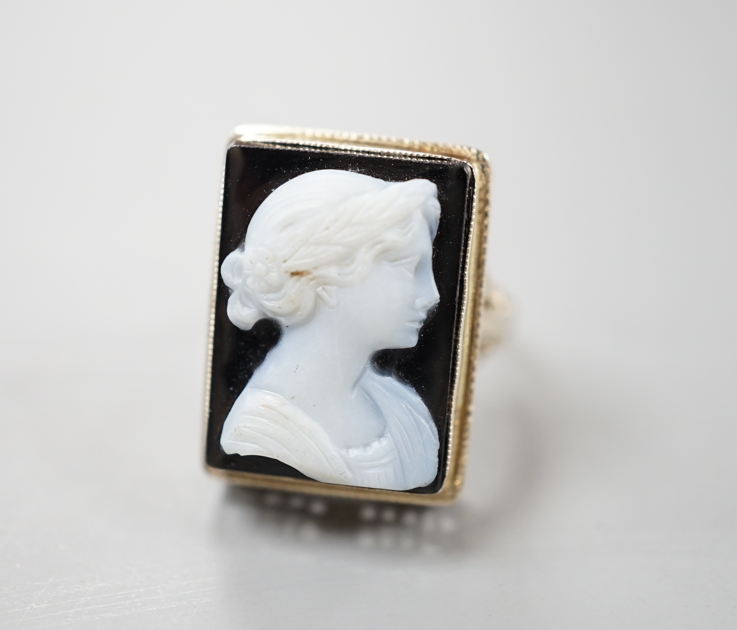 A 14k white metal and hardstone cameo set dress ring, size K/L, gross weight 5.1 grams.